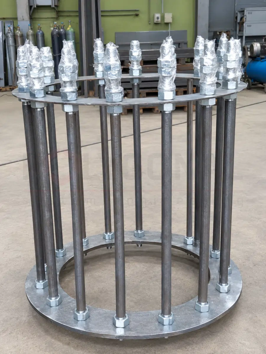 An assembled anchor cage in the workshop: anchor bolts between two rings