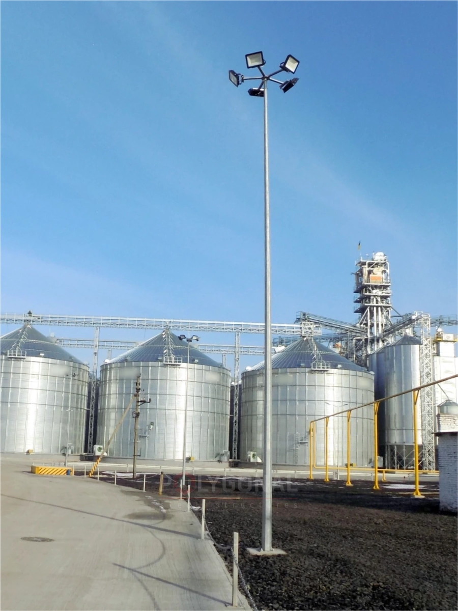 PMO pole with five floodlights next to grain silos